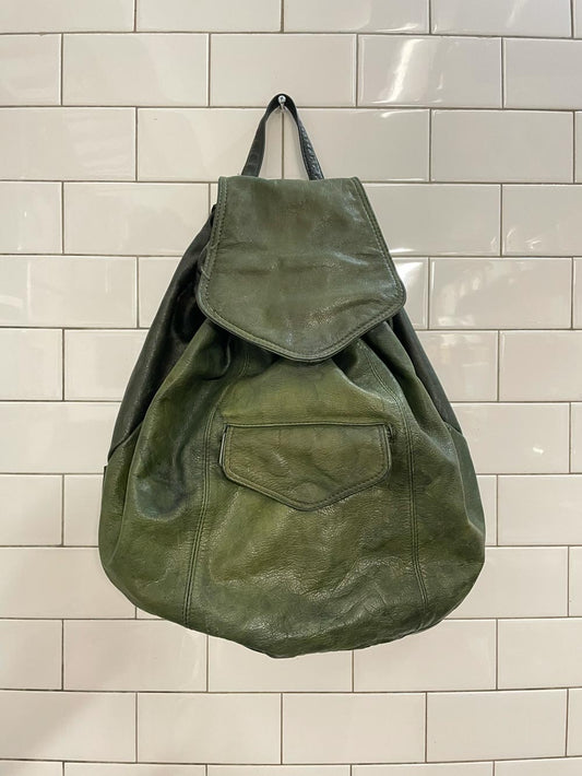 vintage sun-faded green leather backpack