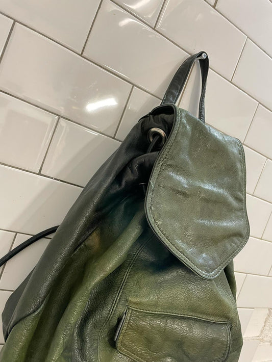 vintage sun-faded green leather backpack